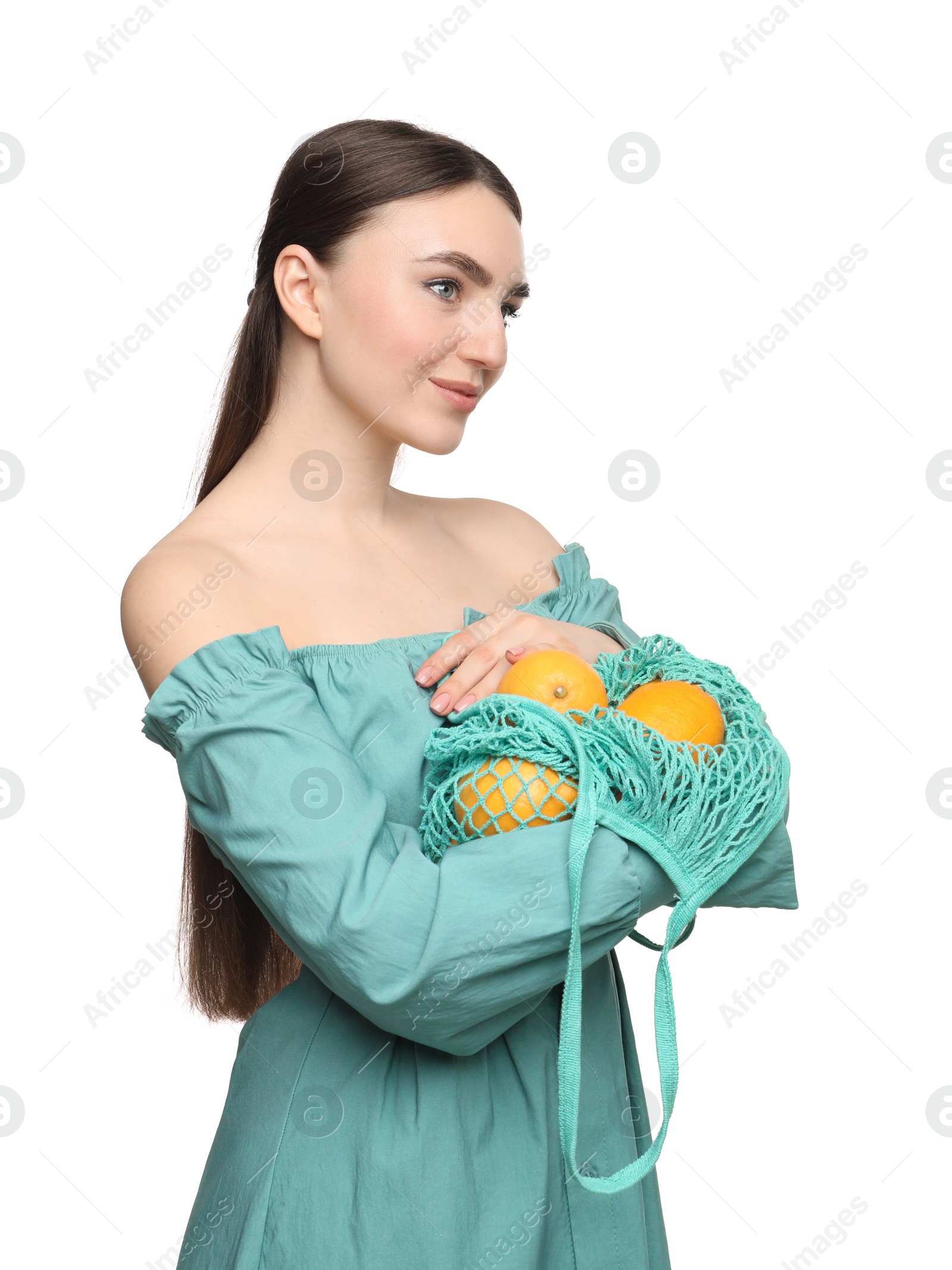 Photo of Woman with string bag of fresh lemons on white background