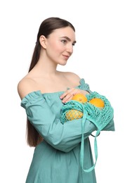 Photo of Woman with string bag of fresh lemons on white background