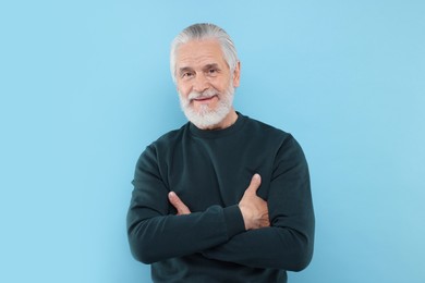 Photo of Portrait of handsome senior man on light blue background