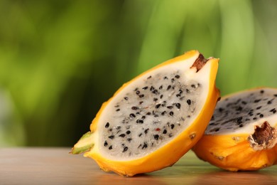 Photo of Delicious cut dragon fruit (pitahaya) on wooden table, closeup