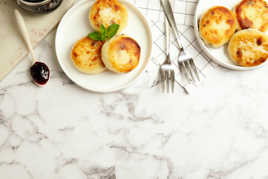 Delicious cottage cheese pancakes on white marble table, flat lay. Space for text