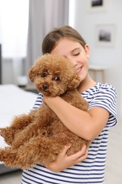 Photo of Little child with cute puppy at home. Lovely pet