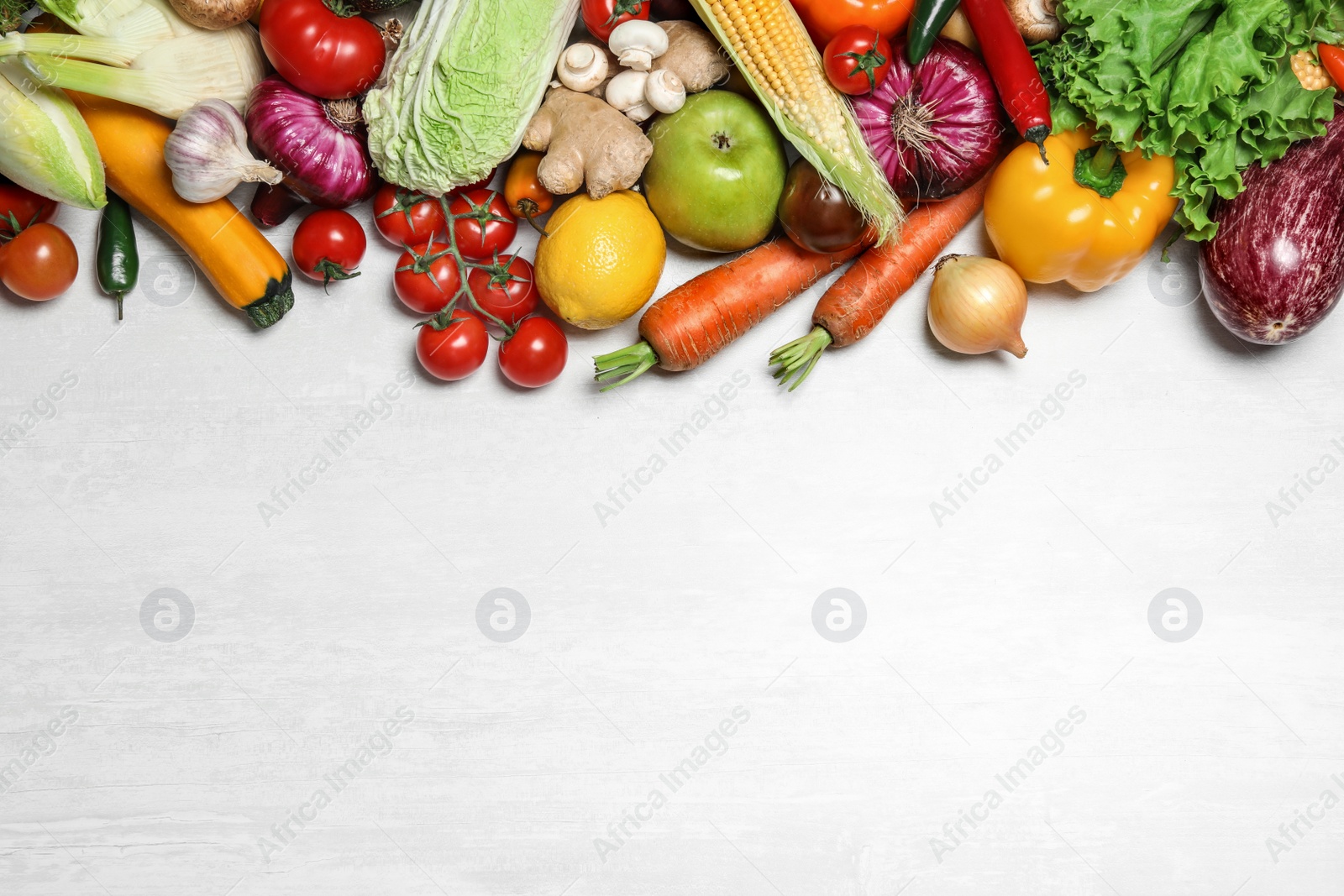 Photo of Different fresh vegetables on light table, flat lay. Space for text