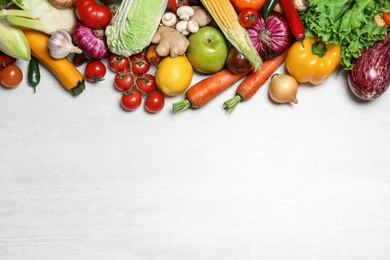 Photo of Different fresh vegetables on light table, flat lay. Space for text