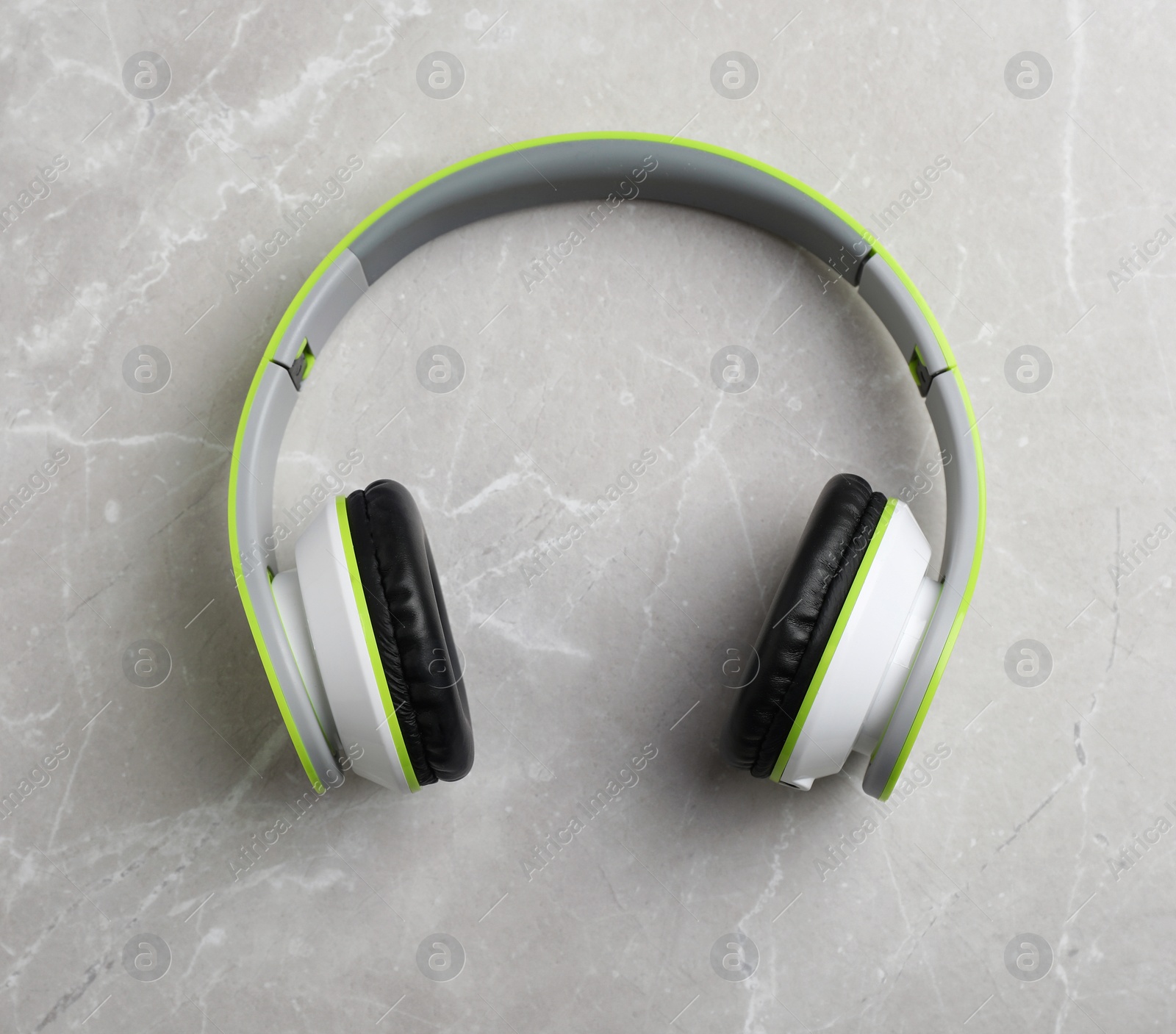 Photo of Stylish modern headphones on gray background, top view