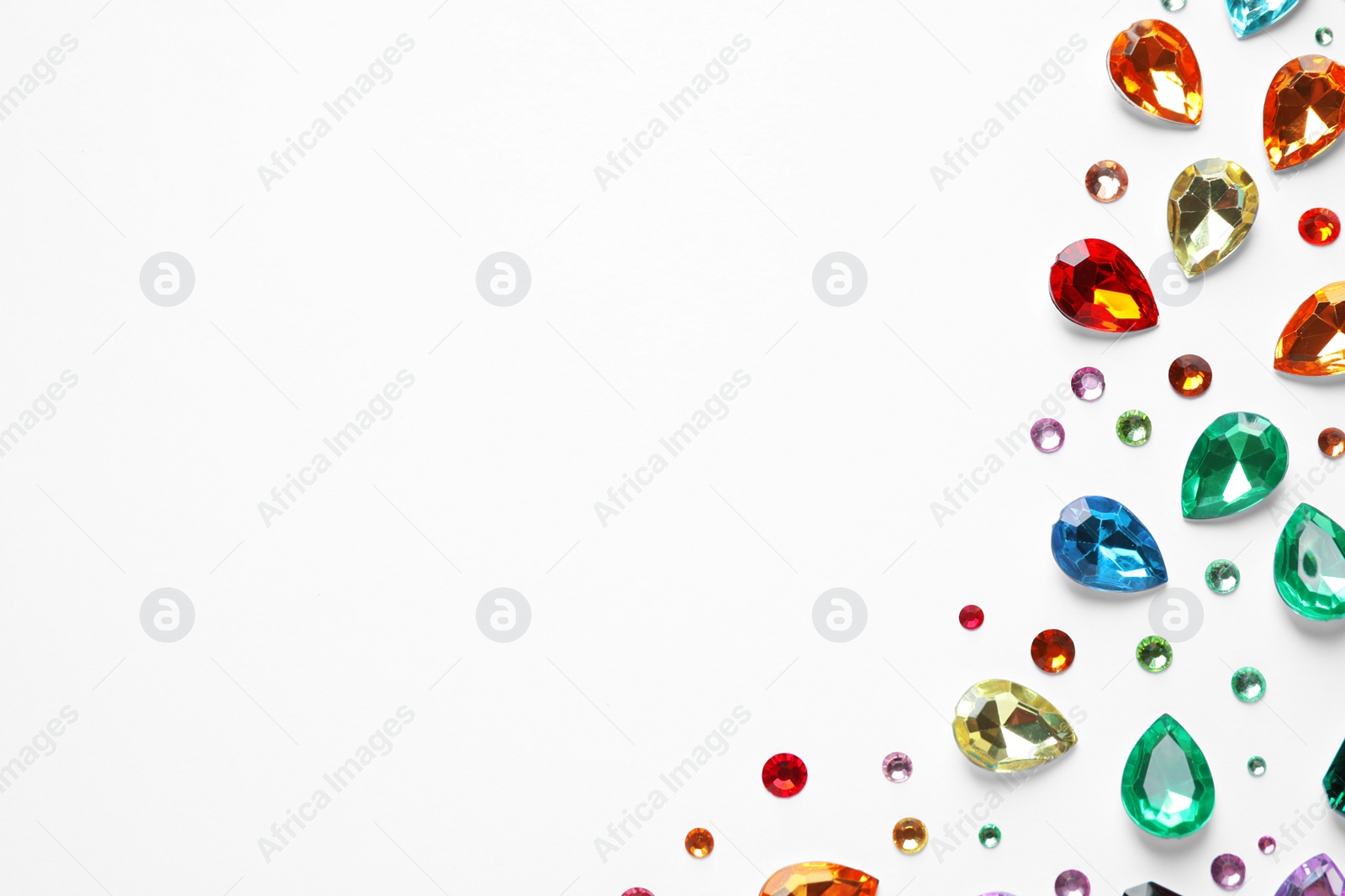 Photo of Different beautiful gemstones on white background, top view