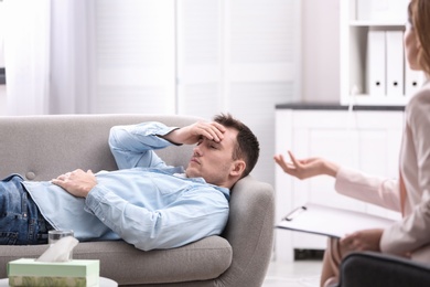 Psychotherapist working with young man in office