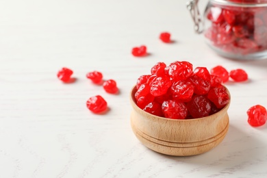 Bowl with tasty cherries on wooden background, space for text. Dried fruits as healthy food