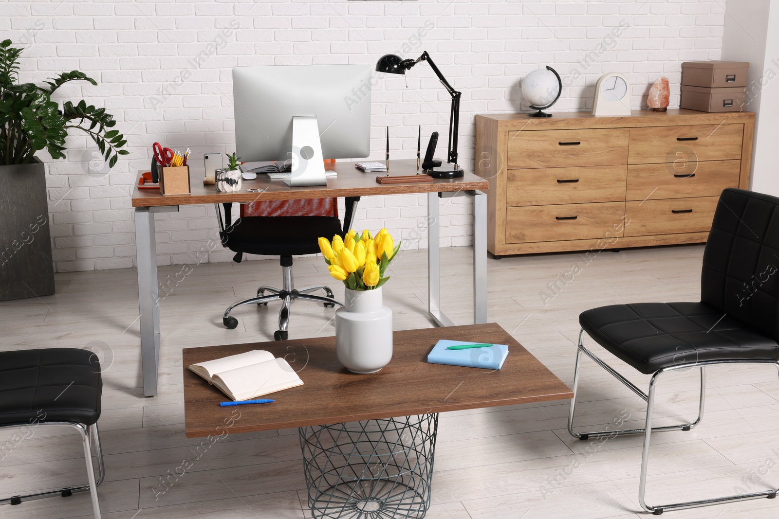 Photo of Stylish director's workplace with comfortable furniture and waiting area in office. Interior design
