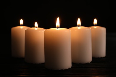 Photo of Burning candles on dark background. Memory day