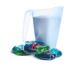 Photo of Color laundry capsules and detergent powder on white background