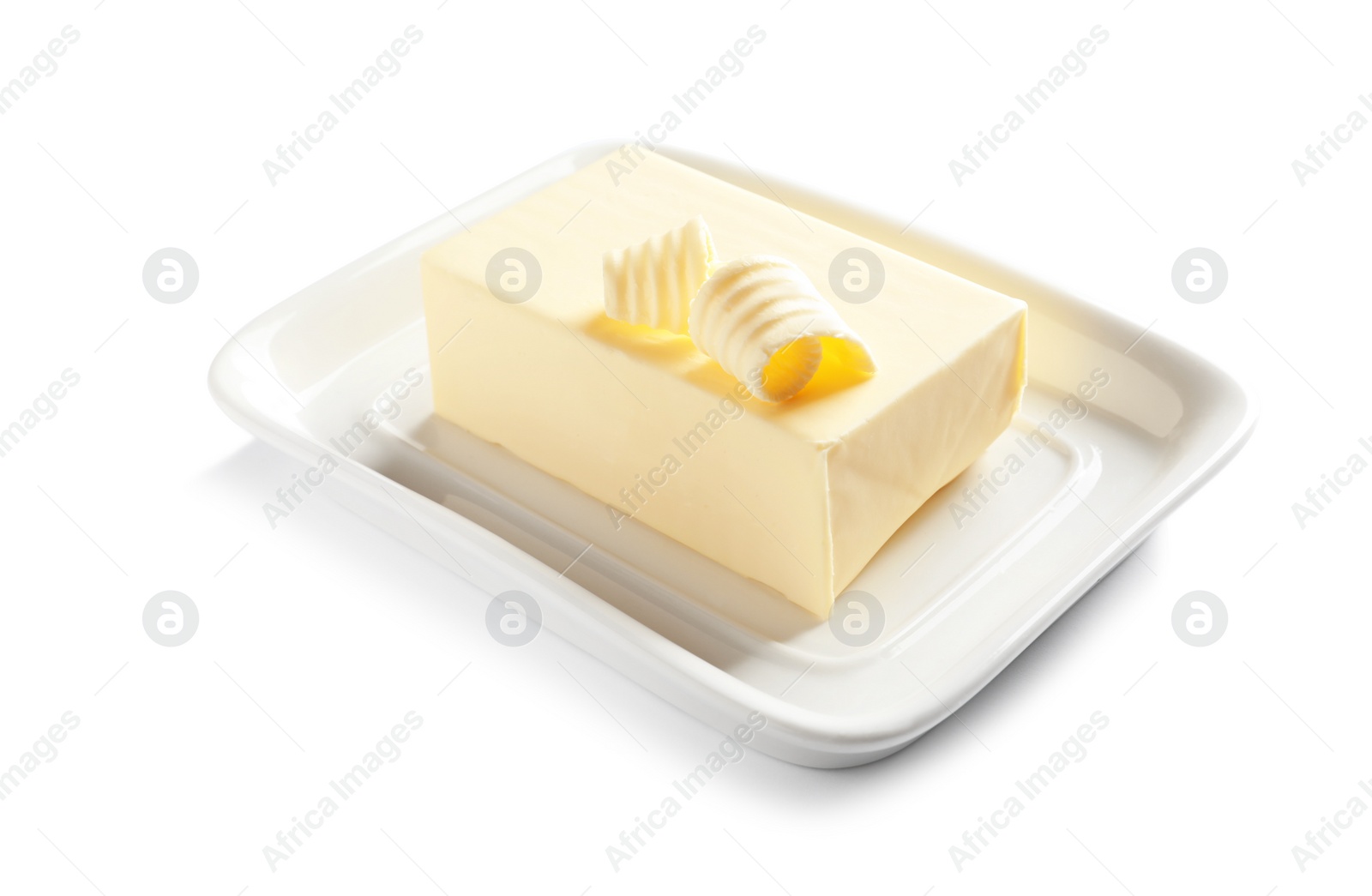 Photo of Ceramic dish with block of fresh butter on white background