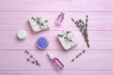 Photo of Flat lay composition with hand made soap bars and lavender flowers on pink wooden table