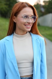 Portrait of beautiful woman in glasses outdoors