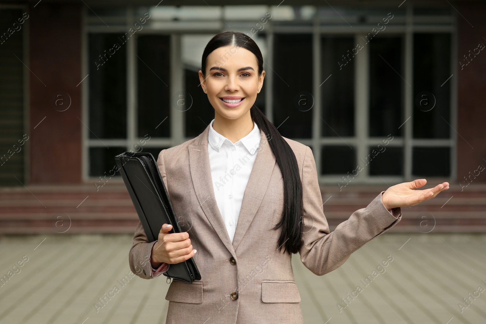 Photo of Beautiful real estate agent with documents outdoors