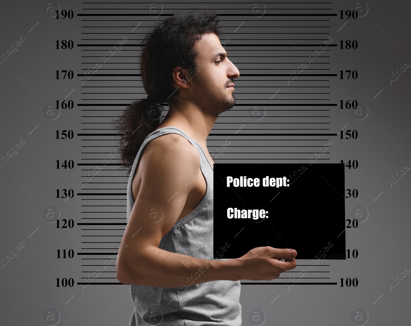 Image of Criminal mugshot. Arrested man with blank card against height chart