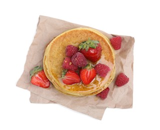 Tasty pancakes with fresh berries and honey on white background, top view