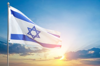 Image of National flag of Israel against blue sky with clouds