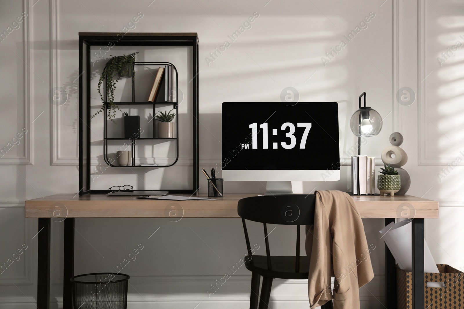 Photo of Modern computer and laptop on wooden desk in room. Interior design