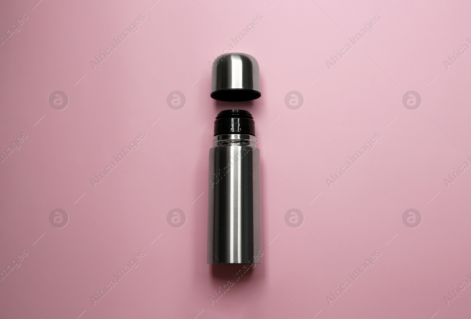 Photo of Stainless steel thermos on pink background, top view