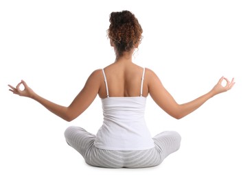 Photo of African-American woman meditating on white background, back view