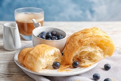 Photo of Tasty croissant with berries on plate