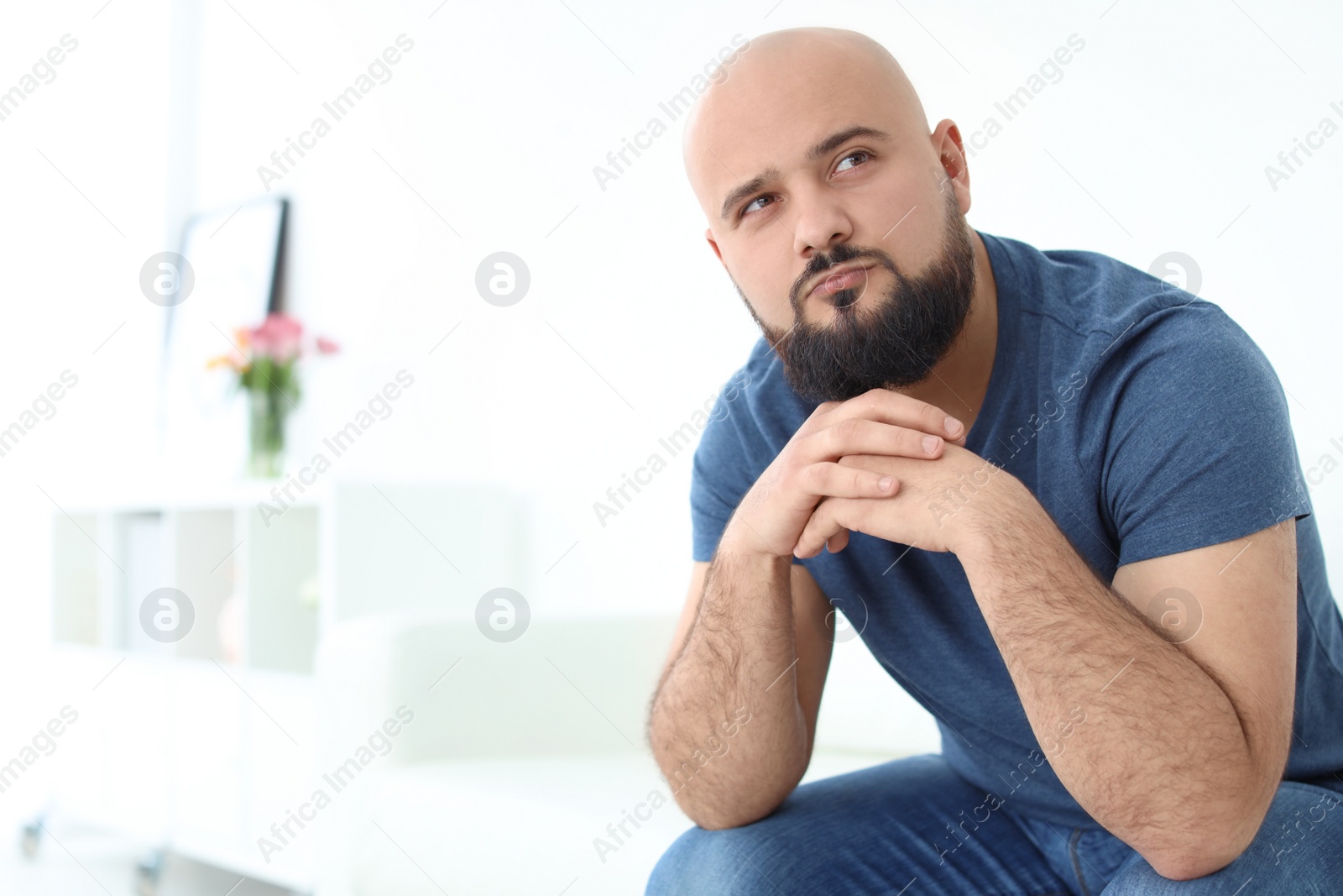 Photo of Portrait of confident young man on sofa