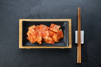 Photo of Delicious kimchi with Chinese cabbage served on grey table