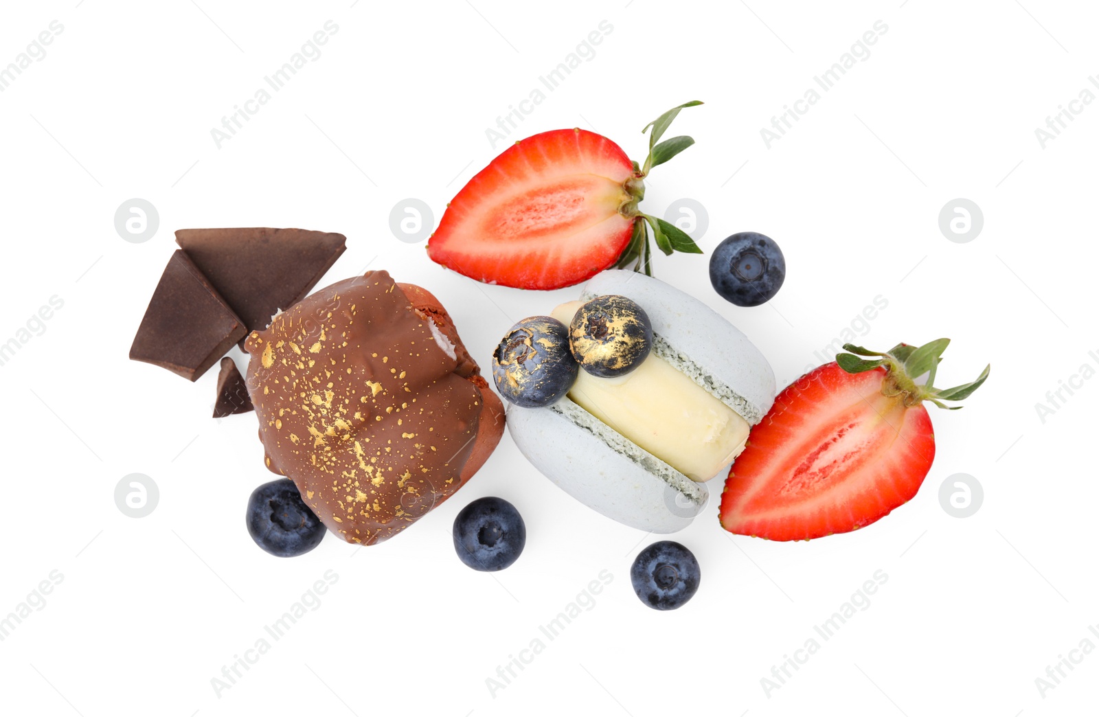 Photo of Delicious sweet macarons, berries and chocolate isolated on white, top view