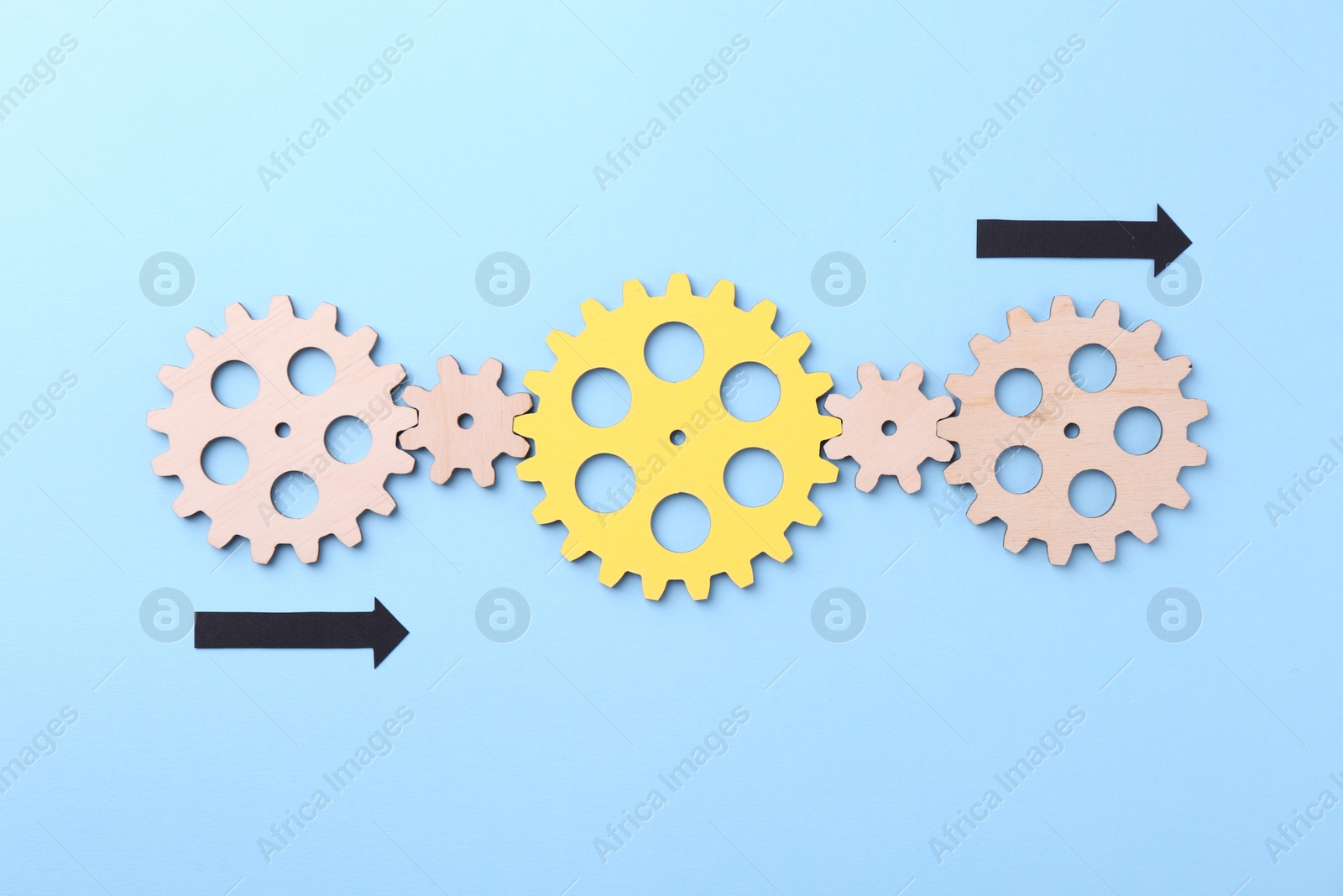 Photo of Business process organization and optimization. Scheme with wooden figures and arrows on light blue background, top view