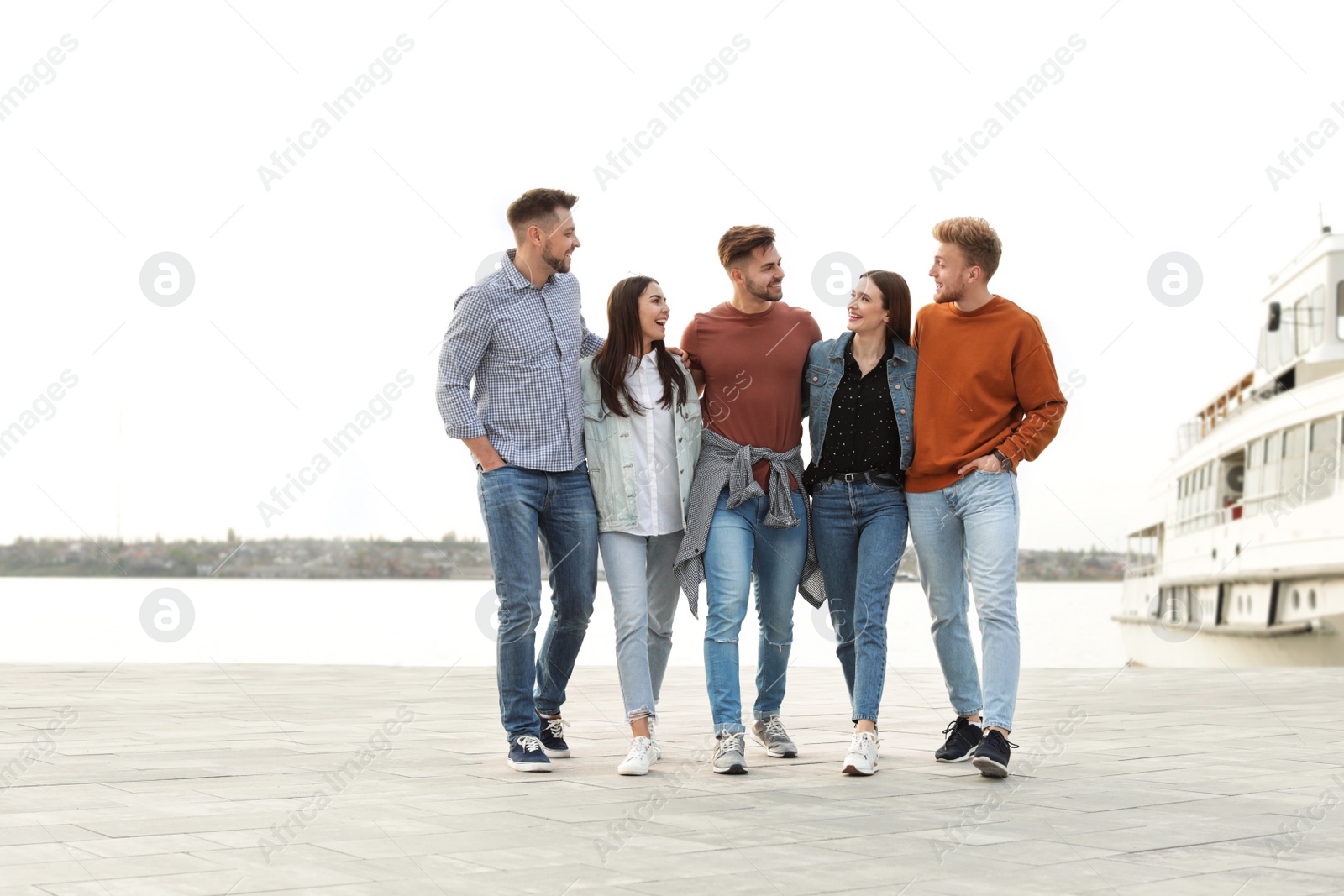 Photo of Group of happy people spending time together at promenade