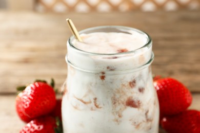 Photo of Tasty yoghurt with jam and strawberries on table, closeup