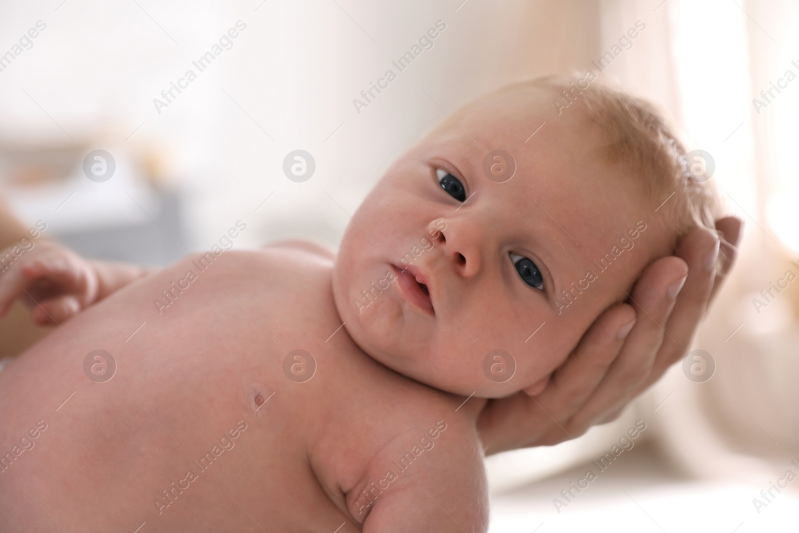 Photo of Father holding his little baby in bedroom, closeup