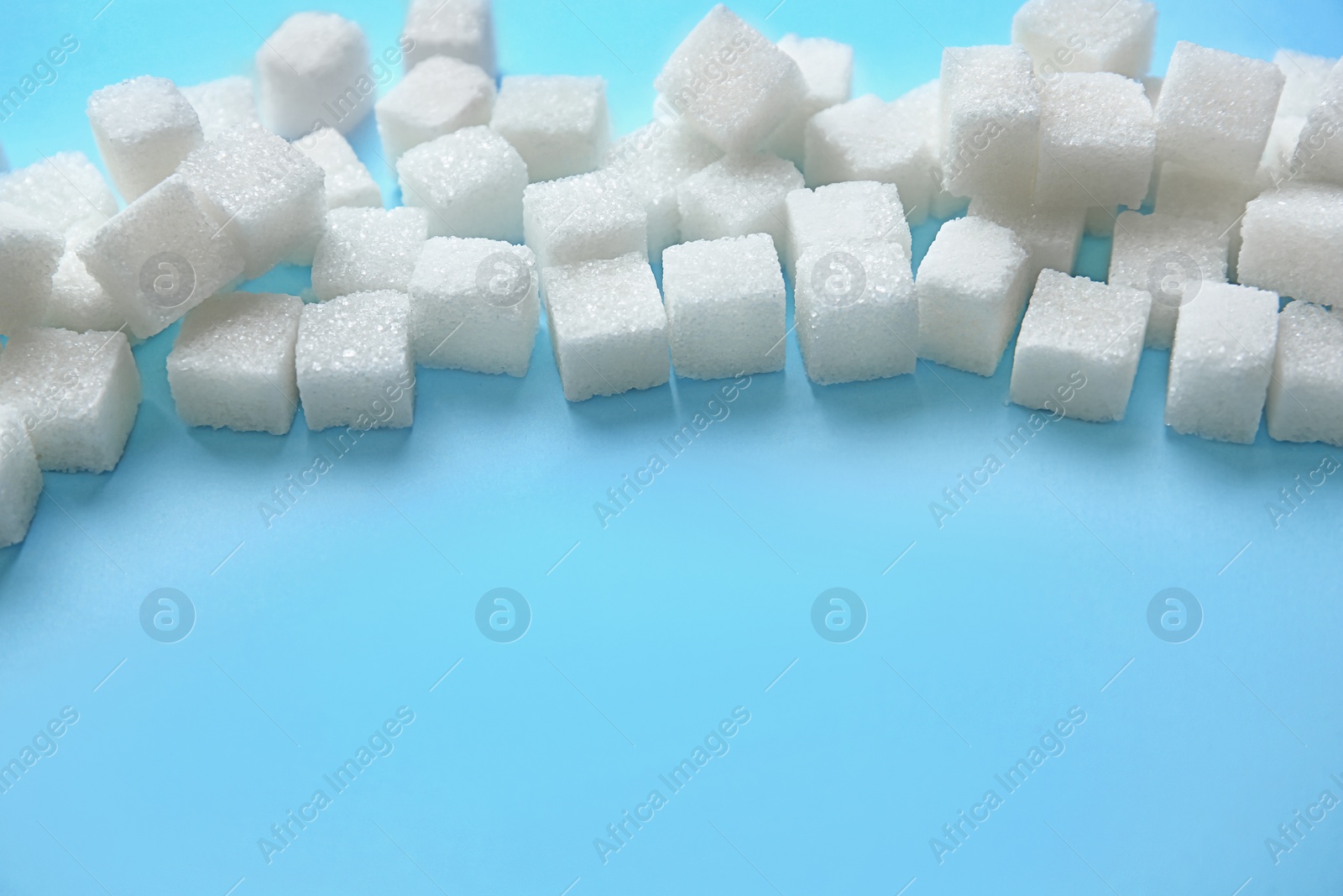 Photo of Refined sugar on color background