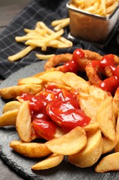 Photo of Delicious baked potato with ketchup on table, closeup