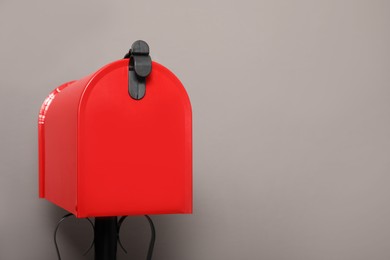 Closed red letter box against grey background. Space for text