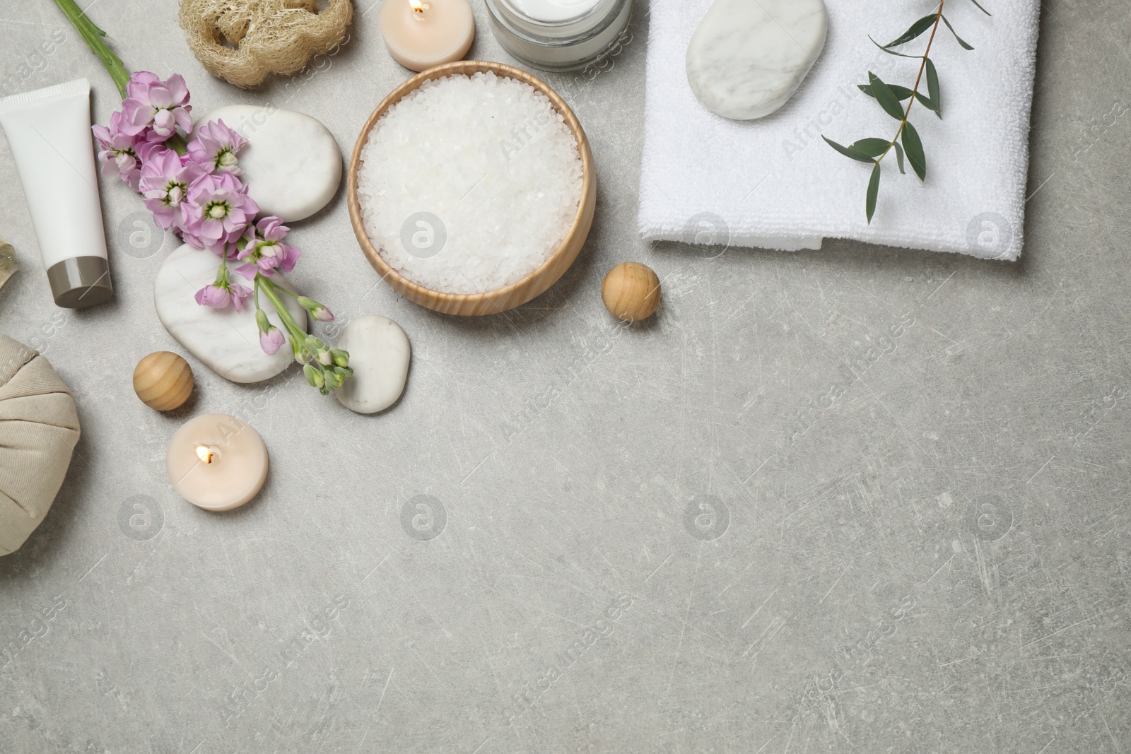 Photo of Flat lay composition with cosmetics on grey marble table, space for text. Spa treatment