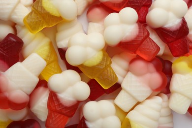 Tasty jelly candies in shape of ice cream as background, top view