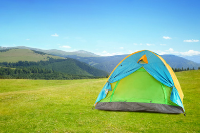 Image of Modern camping tent in mountains on sunny day