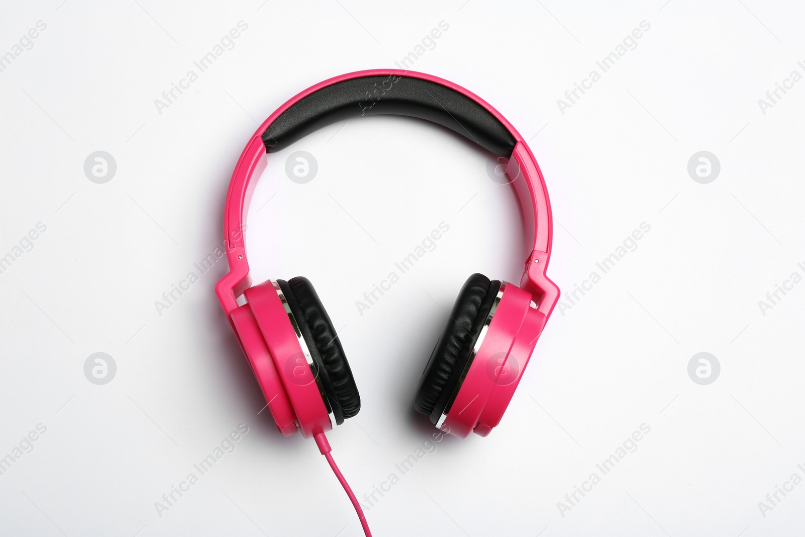 Photo of Stylish modern headphones on white background, top view