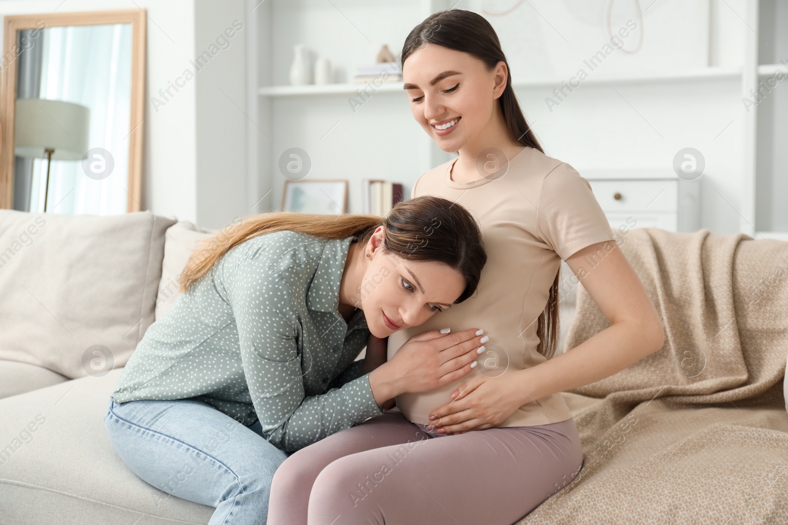 Photo of Doula taking care of pregnant woman at home. Preparation for child birth