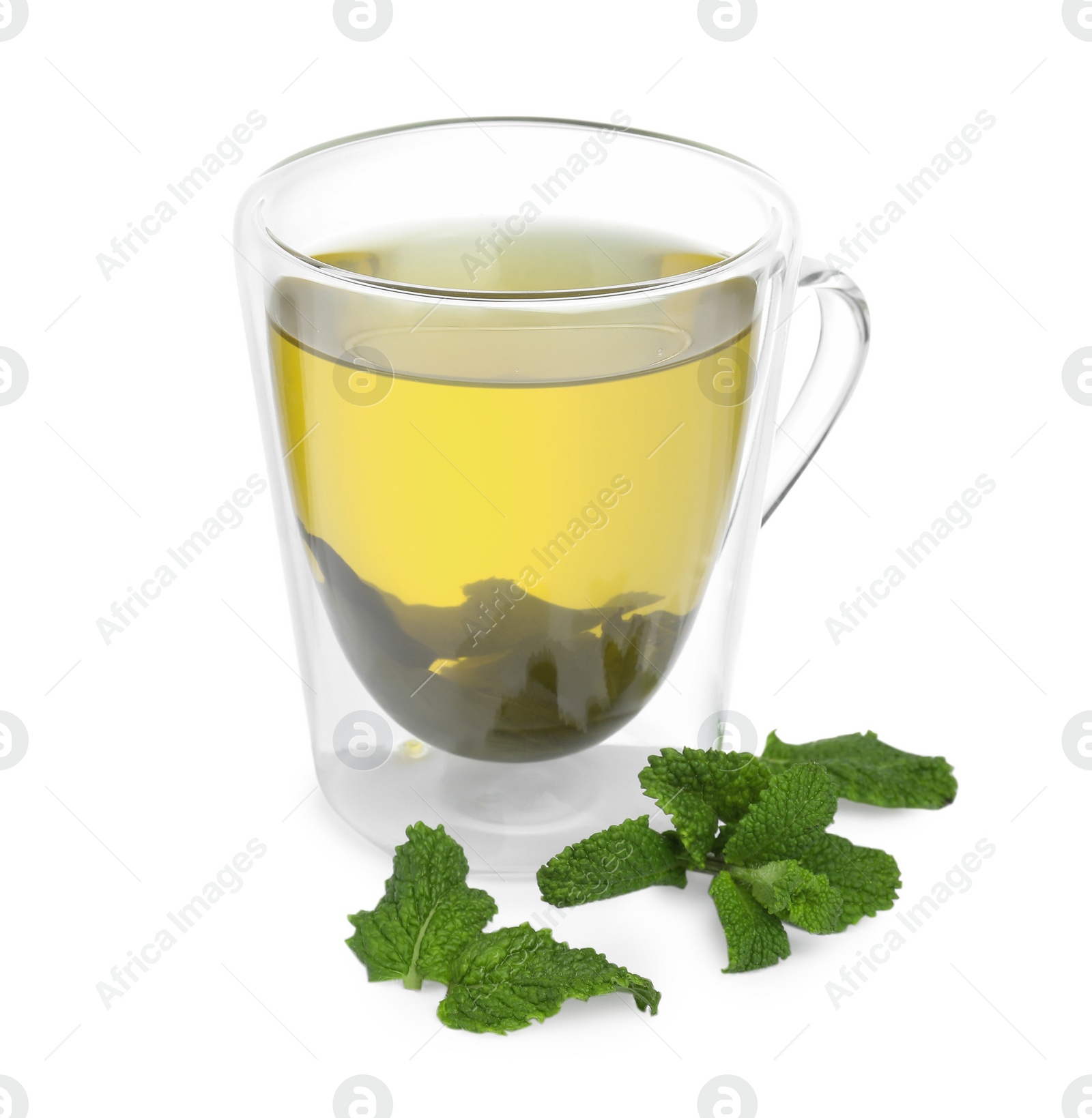 Photo of Fresh green tea in glass mug and mint isolated on white