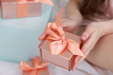 Photo of Woman with gift box indoors, closeup view