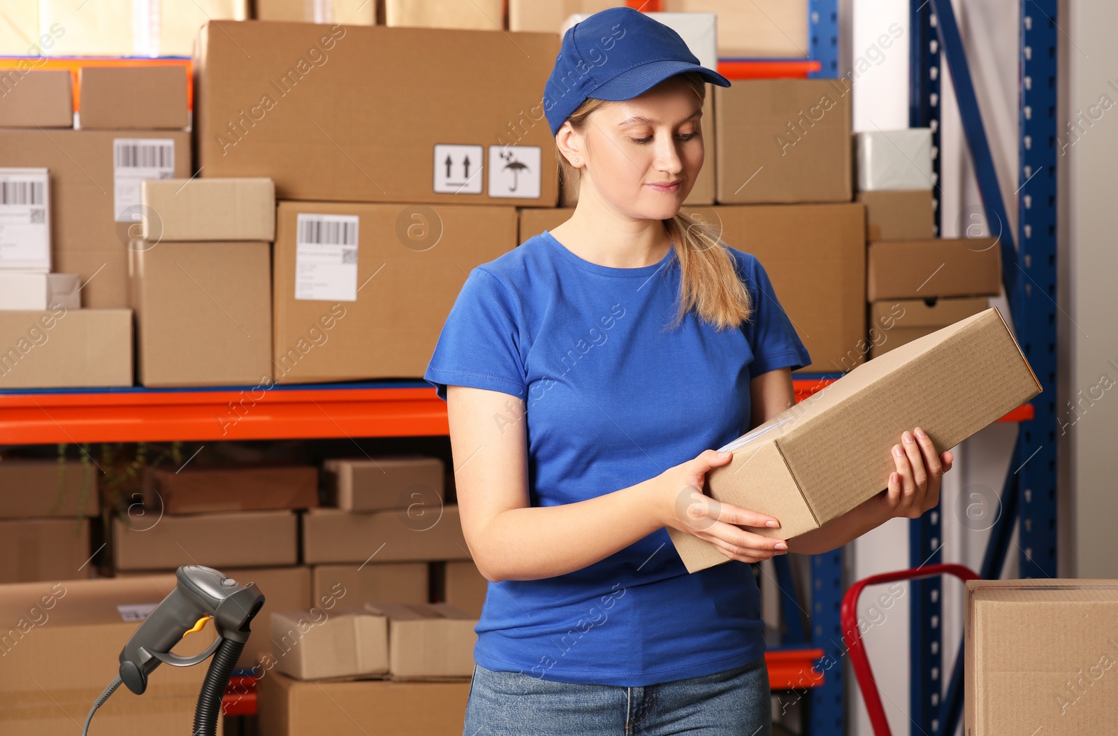 Photo of Post office worker with parcel near rack indoors, space for text