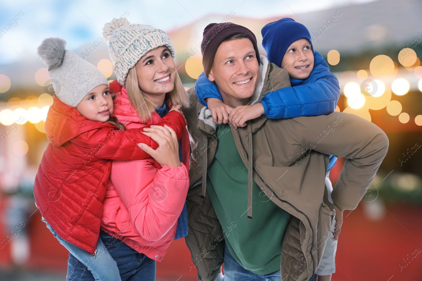 Image of Happy family at Christmas fair. Bokeh effect