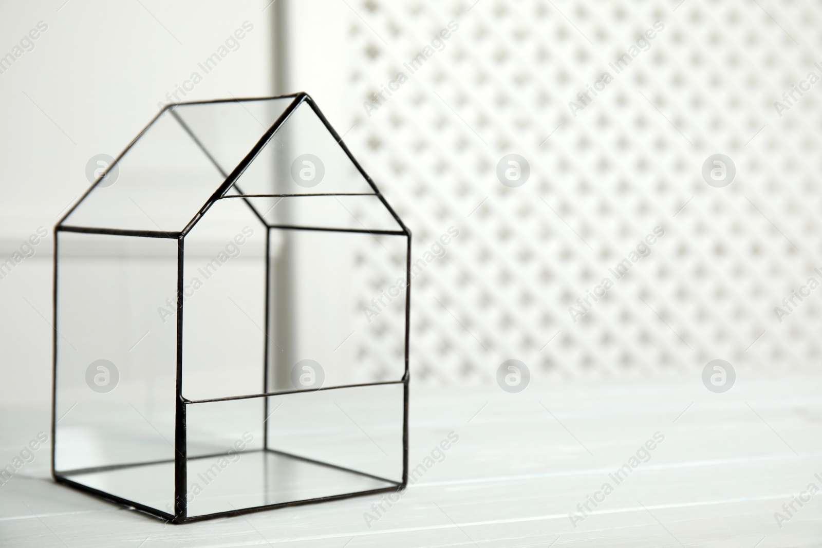 Photo of Empty glass florarium vase on white table indoors, space for text