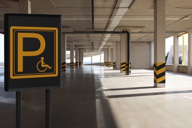 Image of Sign with wheelchair symbol in car parking garage, space for text 
