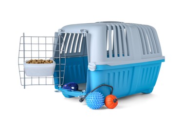 Photo of Light blue pet carrier with bowl of dry food and toys isolated on white