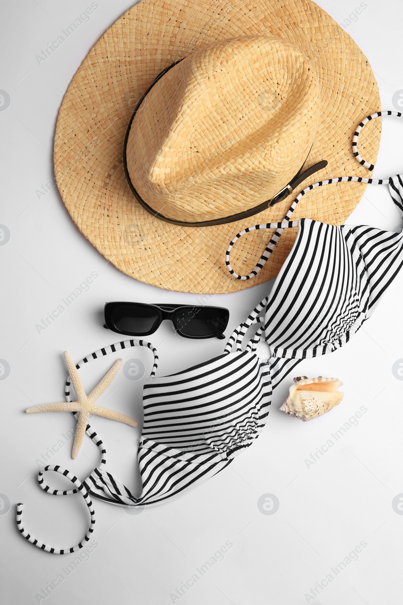 Photo of Flat lay composition with beach accessories on white background