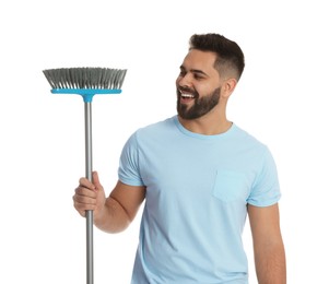 Young man with broom on white background